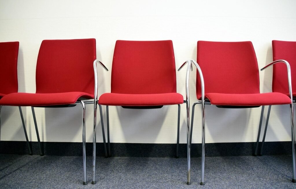 Row of red chairs in a waiting area